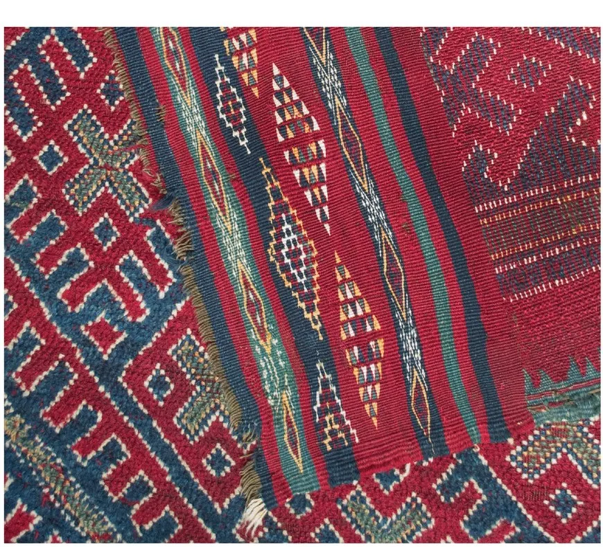 Close-up of cochineal red, indigo blue and green weaving on the Jebel Amour rug