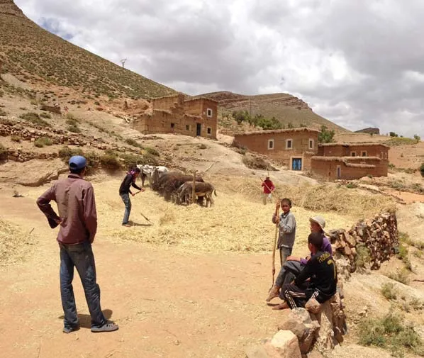 High Atlas village scene with residents and livestock
