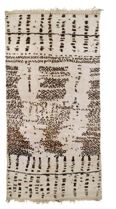 Ivory rug densely covered with black figures, animals and geometric signs