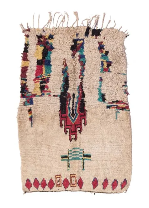 Ivory rug with a sparse central column of red, blue, green and black marks