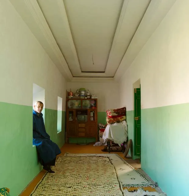Interior corridor with a large pale Berber rug laid on the floor
