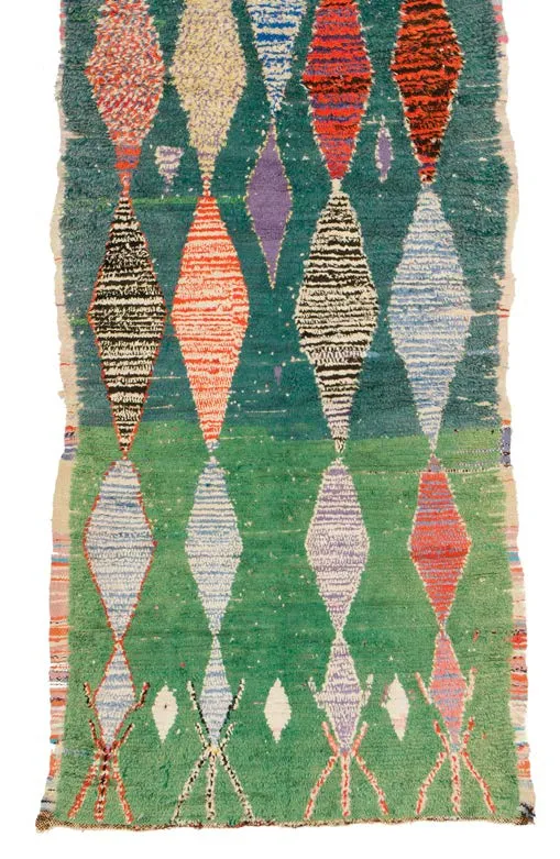 Multicoloured rug with repeating green, red and purple lozenges