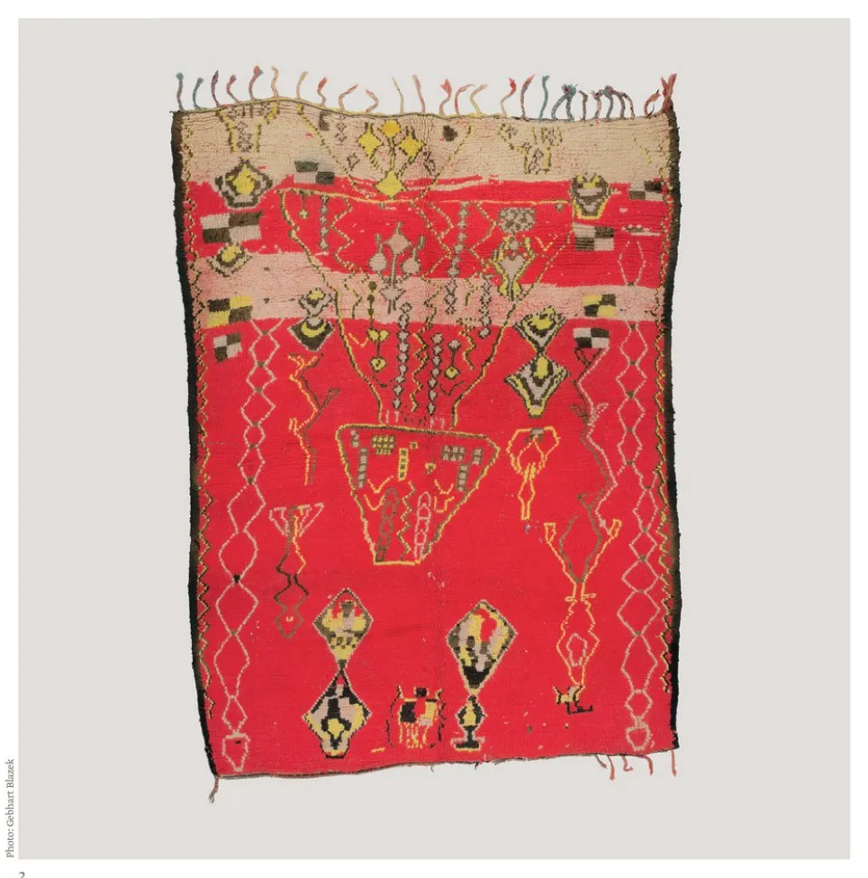 Bright red rug with improvised animals, figures and angular lines