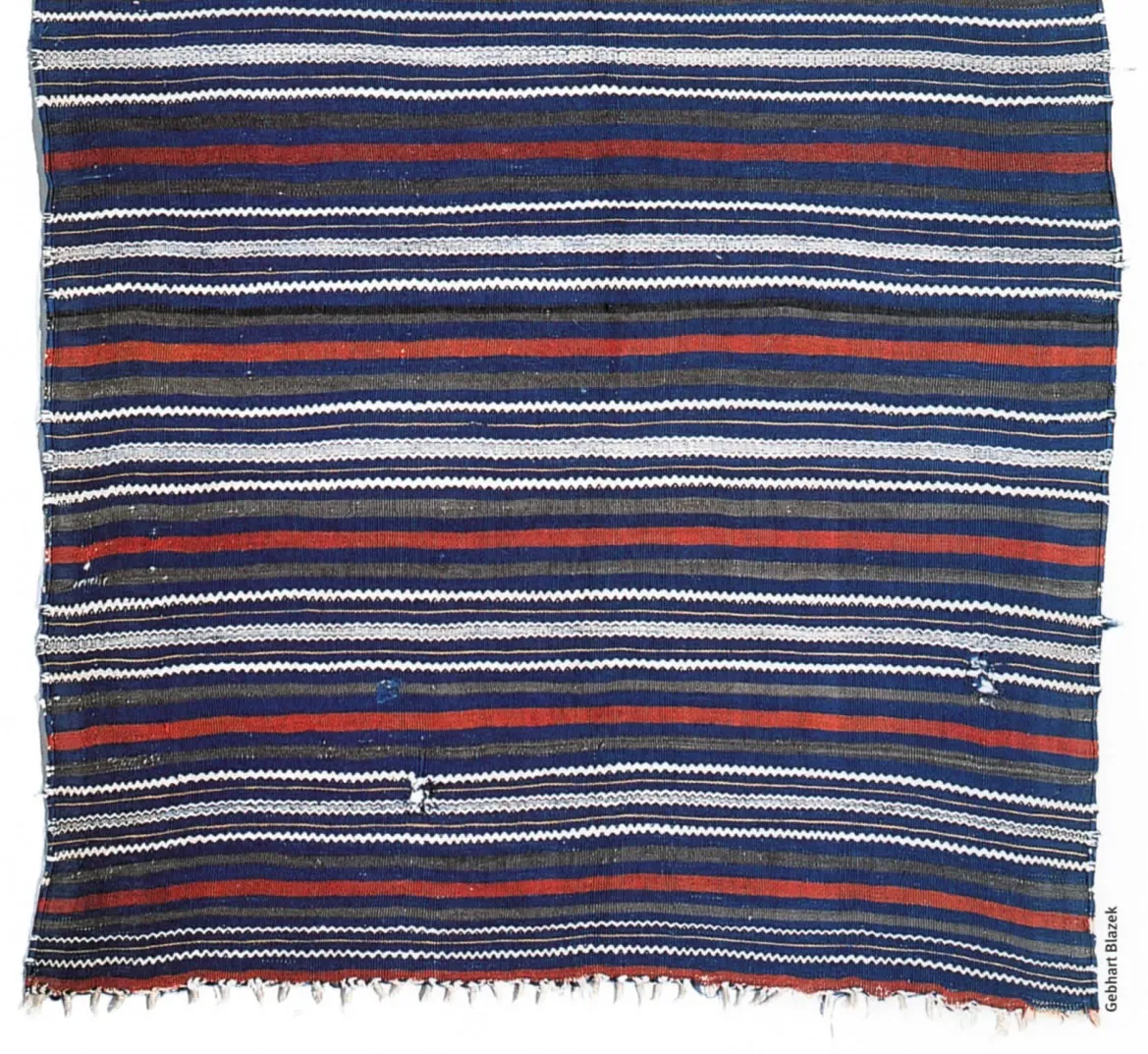 Deep blue shawl crossed by red, white and patterned horizontal bands