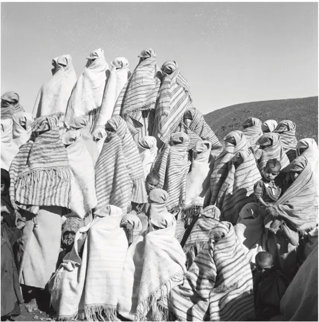 Historic photograph of Tiznit women wearing striped haiks