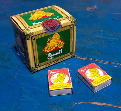 Moroccan matchboxes and tin decorated with a yellow lion emblem