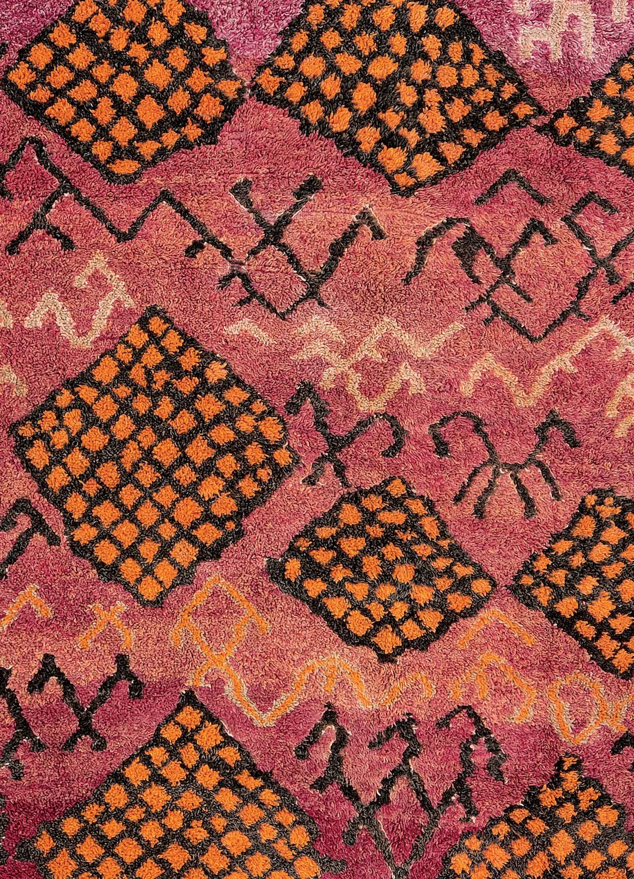 Detail of an orange-and-black geometric motif on a Moroccan pile rug