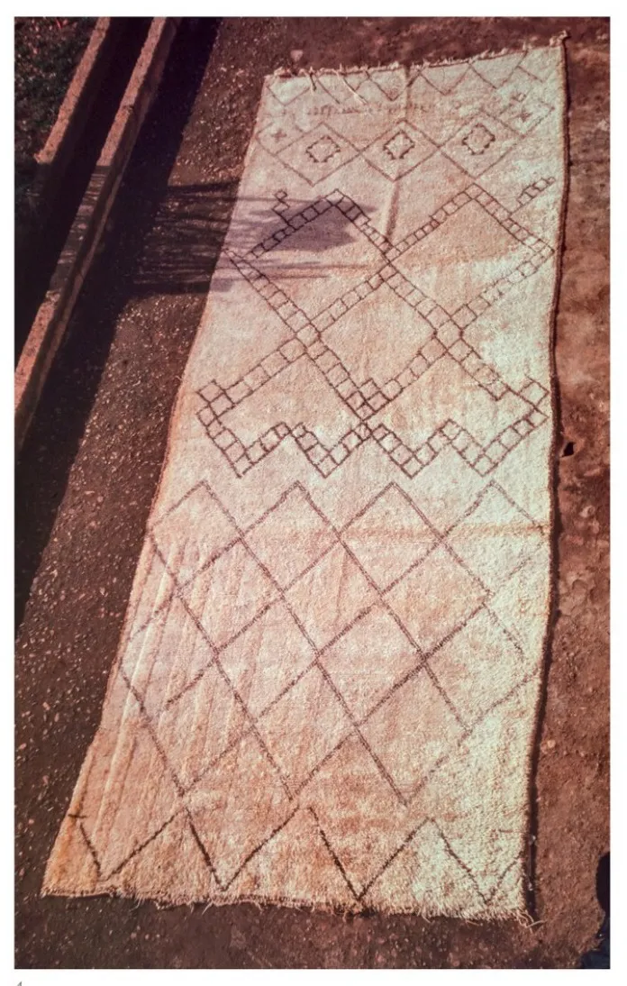 Loosely patterned white Beni Ouarain rug photographed outdoors